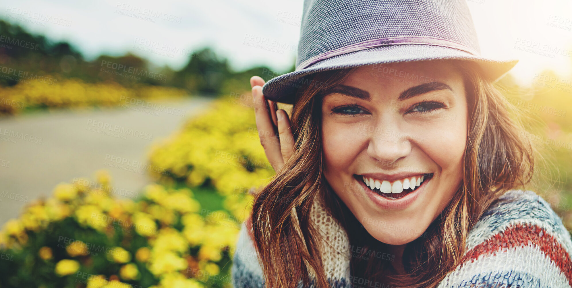 Buy stock photo Woman, portrait and flower field with smile in nature or autumn environment, countryside or outdoor. Female person, face and floral in sunshine with happiness in England or meadow, holiday or explore