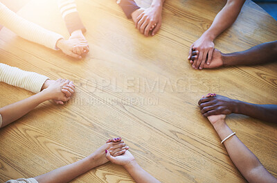 Buy stock photo Teamwork, holding hands and business people on table in office for collaboration, community and agreement. Startup company, diversity and above of men and women for meeting, support and team building