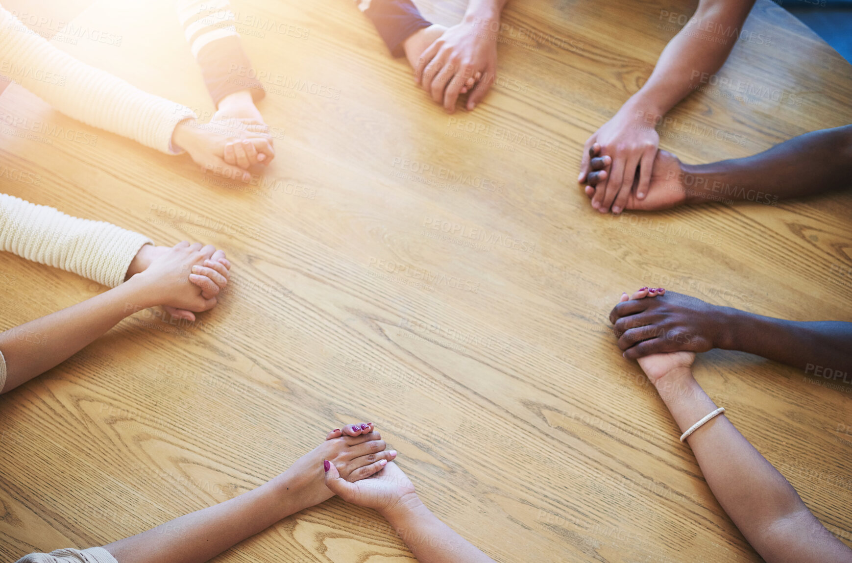 Buy stock photo Teamwork, holding hands and business people on table in office for collaboration, community and agreement. Startup company, diversity and above of men and women for meeting, support and team building