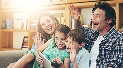 Buy stock photo Happy family, video call and waving with tablet on sofa for communication or conversation together at home. Mom, dad and young children with smile on technology for virtual discussion in living room