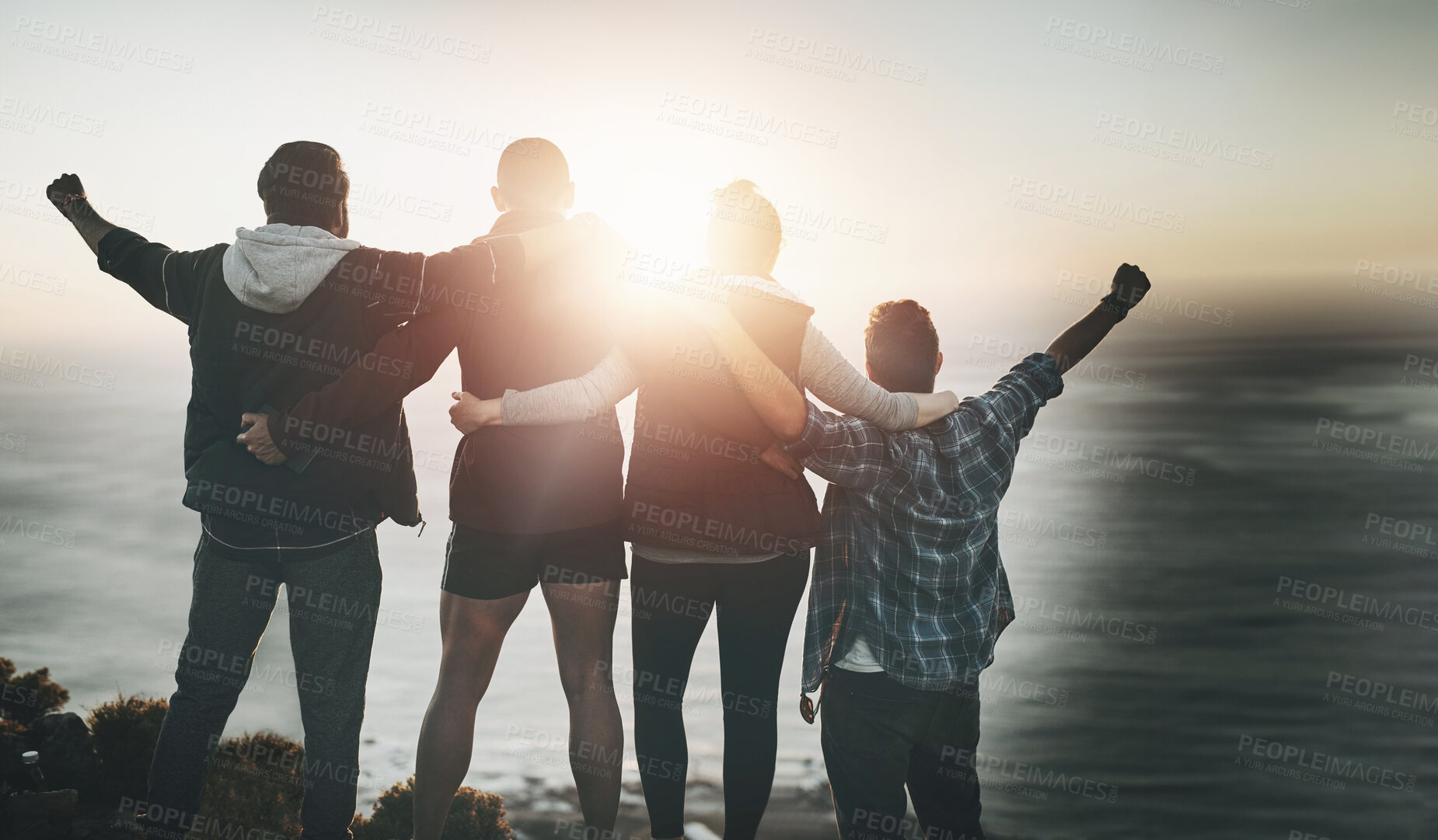 Buy stock photo Mountains, group and friends with hiking, celebration and excited with happiness, lens flare and cheering. Motivation, hiker and people with ocean, achievement and cheerful with joy, nature and goals