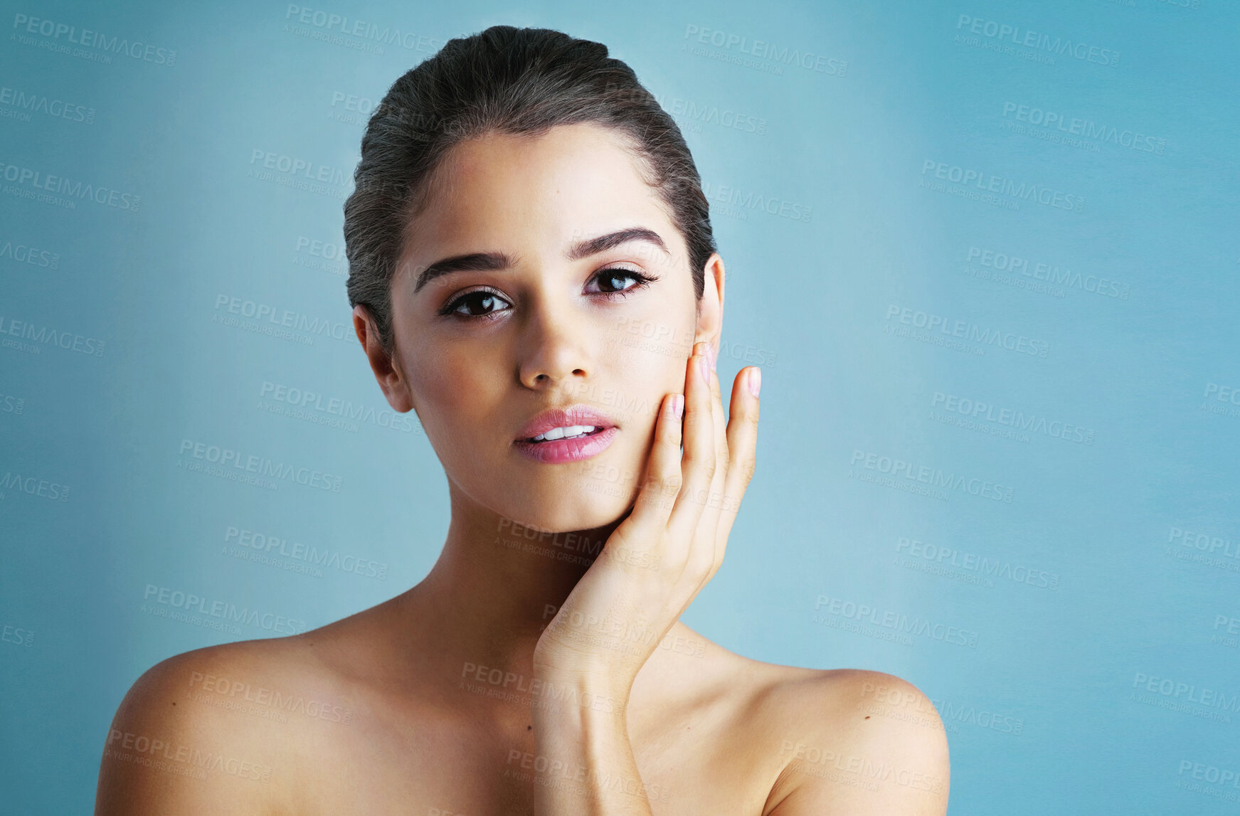 Buy stock photo Woman, portrait and hand for skincare health in studio on blue background, dermatology or mockup space. Female person, face and touch with cosmetic beauty or makeup treatment, confidence or wellness