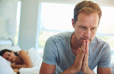 Buy stock photo Thinking, married and man in bedroom at house with stress, anxiety and problem of secret from cheating on sleeping woman. Frustrated, male person and fear of infertility dream with insomnia crisis