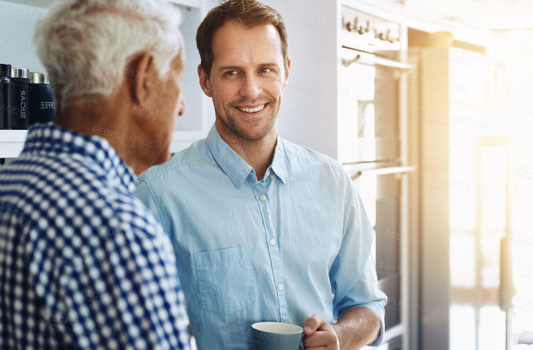 Buy stock photo Man, happy and senior father in kitchen with conversation in morning with coffee for bonding in retirement. Proud, dad and son on weekend with together in home for family dinner in the Netherlands.