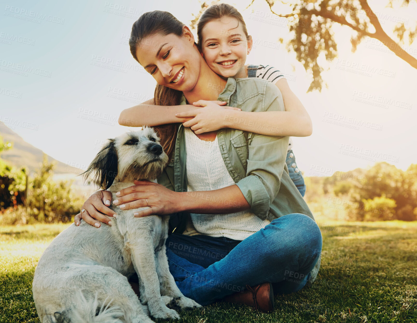 Buy stock photo Mother, girl and playing with dog in park for bonding, relax and happy with fun activity in nature. Family, woman and daughter with puppy on grass in environment with sunlight, portrait and smile