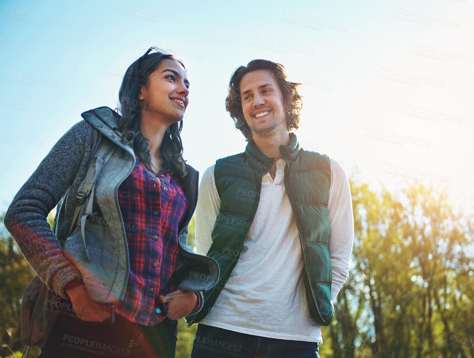 Buy stock photo Happy, young couple in park or nature together for holiday, vacation and romantic weekend break. Smiling, man and woman relax in forest or green environment for peace, love and summer travel 