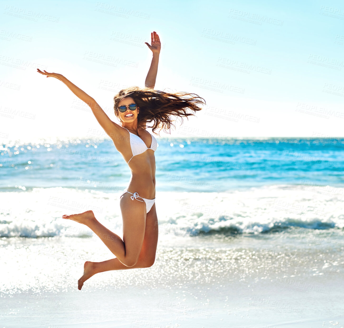 Buy stock photo Excited, jump and portrait of woman at beach for summer adventure, energy and travel on holiday. Happy, tourist and hands in air with celebration for tropical, island vacation and freedom in Bali