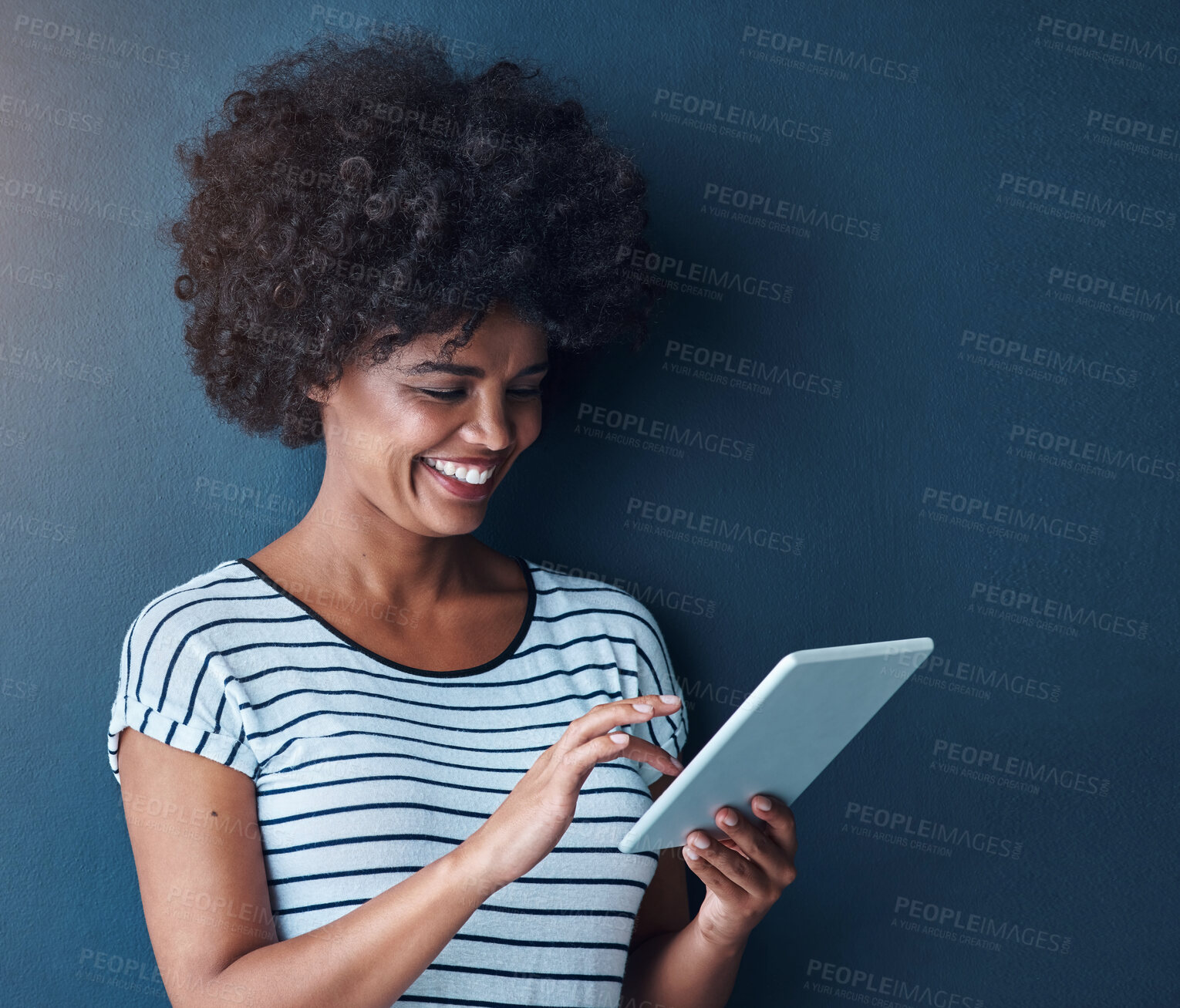 Buy stock photo African student, girl and tablet in studio for reading, thinking or study on app for test by blue background. Person, woman and click on digital touchscreen, online course or elearning for education