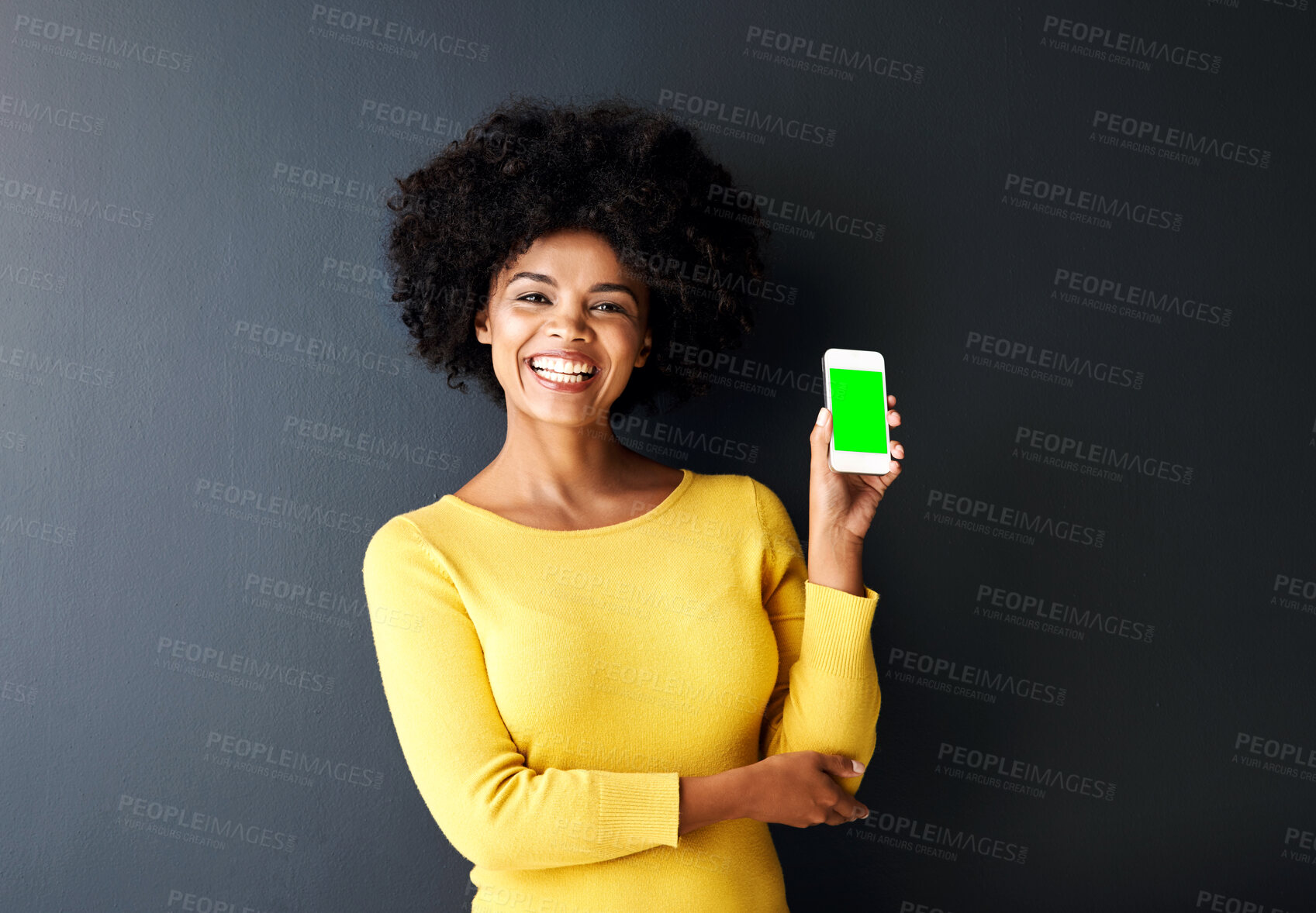 Buy stock photo Happy, black woman and green screen on smartphone in portrait on studio background with chromakey. Cheerful, female person and tech in studio with mockup space in streaming, movie for entertainment
