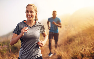 Buy stock photo Smile, woman and running for race in outdoor for marathon competition with fitness, exercise and cardio training in forest for health. People, man and athlete as runner together for challenge workout