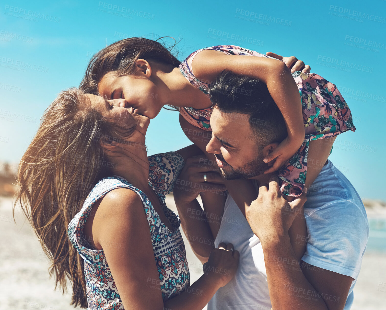 Buy stock photo Family, parents and girl child on beach kiss with love for holiday, vacation and development together on trip. Happy, man and woman on seashore with kid for bonding, adventure and explore bali water