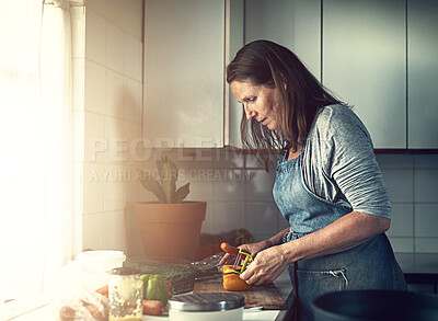 Buy stock photo Cooking, mature and woman in kitchen for healthy food or vegetables for lunch or dinner by window. Apron, natural and senior person in home for meal prep, nutrition or salad preparation in England