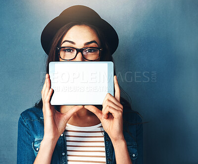 Buy stock photo Woman, studio and tablet with screen on face in portrait for announcement, news for digital platform. Female influencer, blue background and glasses for tech notification, mockup for online network