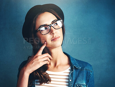 Buy stock photo Woman, hat and glasses in studio with thinking of idea for problem solving, solution or planning with mockup. Person, eyewear or thoughtful with trendy fashion with doubt or unsure on blue background