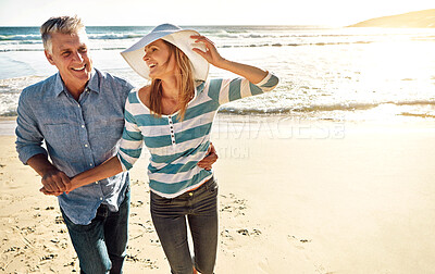 Buy stock photo Happy couple, beach and holding hands on vacation, travel or summer holiday for love in nature. Mature man, woman and smile at ocean for adventure, support or laughing on date together outdoor at sea