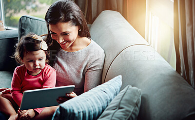 Buy stock photo Education, mother and child with tablet on sofa together for internet connection and development in home. Woman, kid or daughter with tech on couch for online learning and studying with love