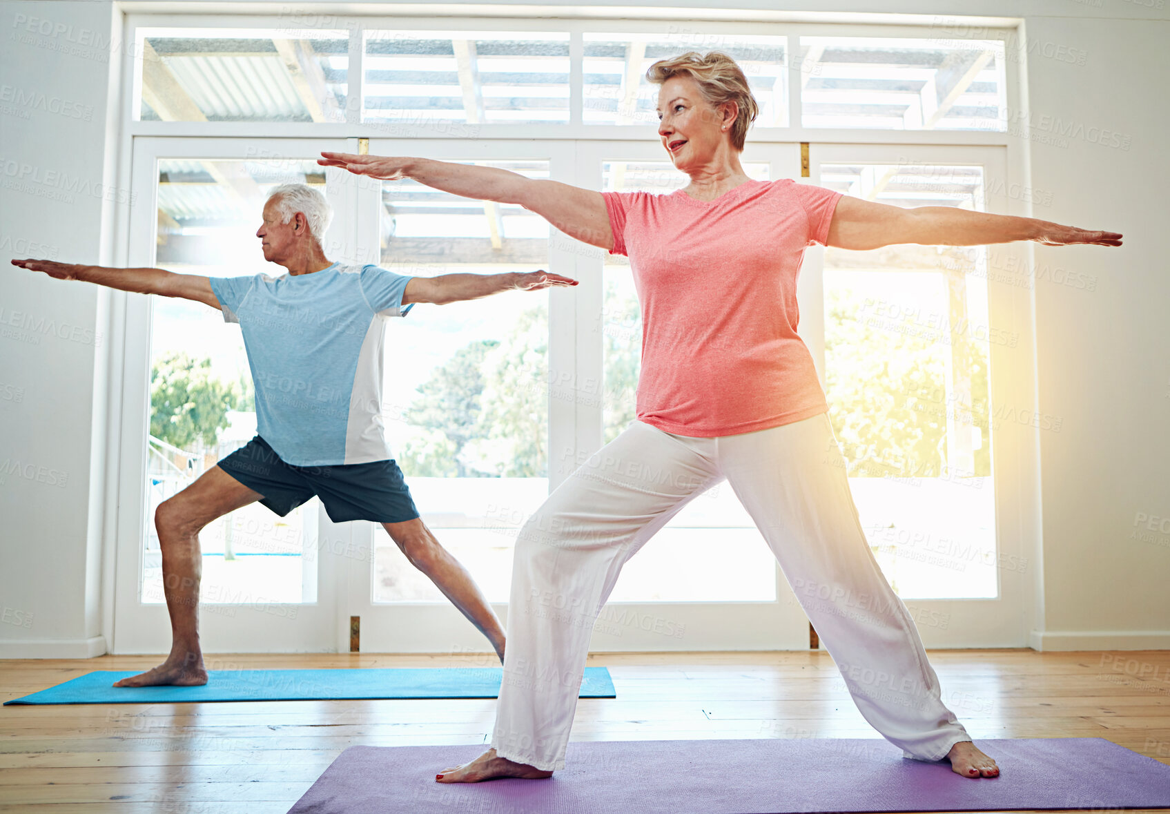 Buy stock photo Yoga, stretching and mature couple in home for fitness, health and wellness with warrior pose. Workout, senior man and woman on mat for pilates, balance and body care exercise together in retirement.