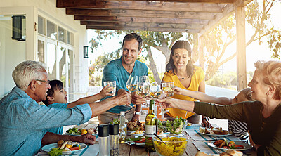 Buy stock photo Food, love and big family with champagne toast on a patio for event, party or birthday celebration. Wine, cheers and group of people in backyard for brunch, bonding or care, support and lunch reunion