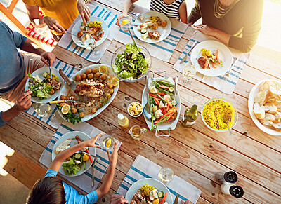 Buy stock photo Table, food and above of family for lunch, supper and eating meal at home together. Celebration, parents and children with dish for bonding, relax and talking for nutrition, health and wellness