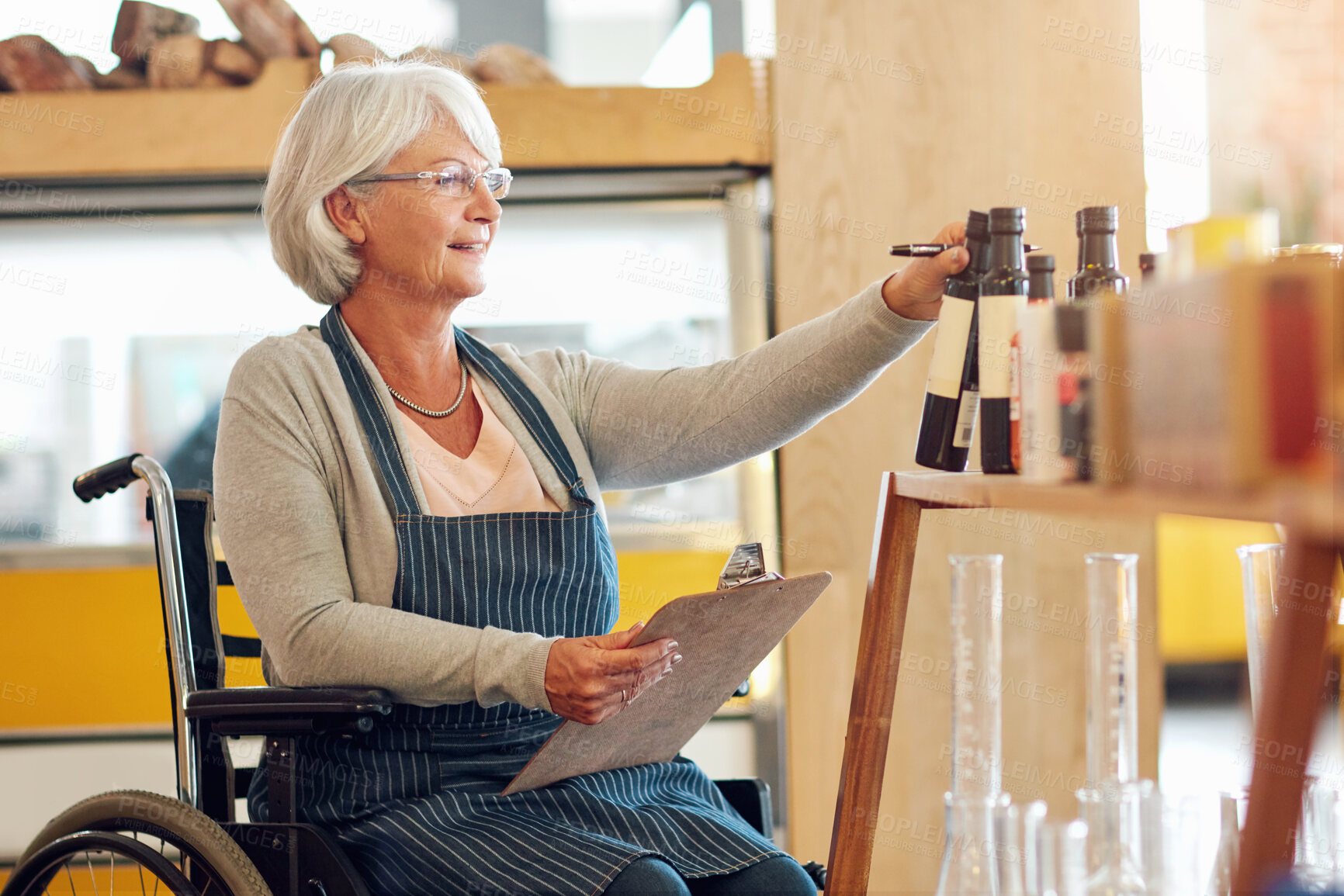 Buy stock photo Senior, woman and happy in wheelchair at business with clipboard for inventory check and quality control. Businesswoman, owner or smile in coffee shop with supply chain, confidence or stock checklist