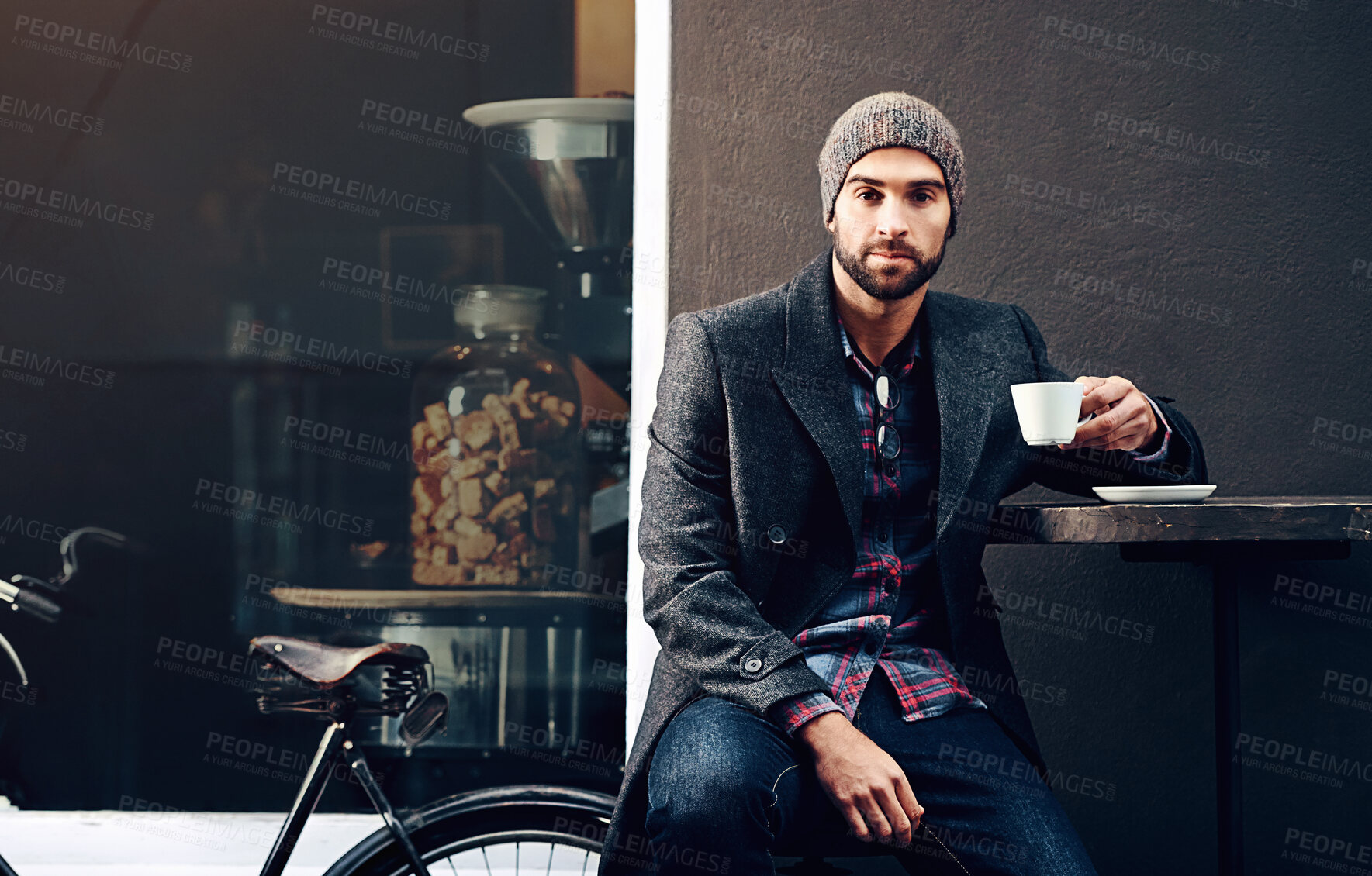 Buy stock photo Coffee break, man and cafe with bicycle portrait and morning commute at table in urban restaurant. Serious, diner and relax with sustainable and eco friendly travel in a shop with hot drink and bike