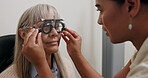 Optometry, optician and woman with trial lens for eye exam, health and wellness in optical store. Ophthalmology, vision and optometrist with senior female patient with prescription testing in shop.