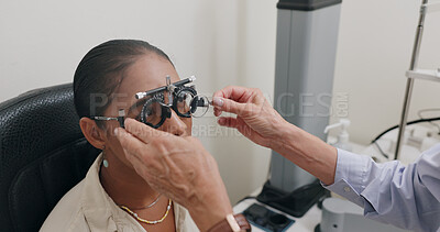 Ophthalmology, hands and woman with trial lens for eye exam, health and wellness in optical store. Optometry, vision and optician with female patient with prescription testing at consultation in shop.