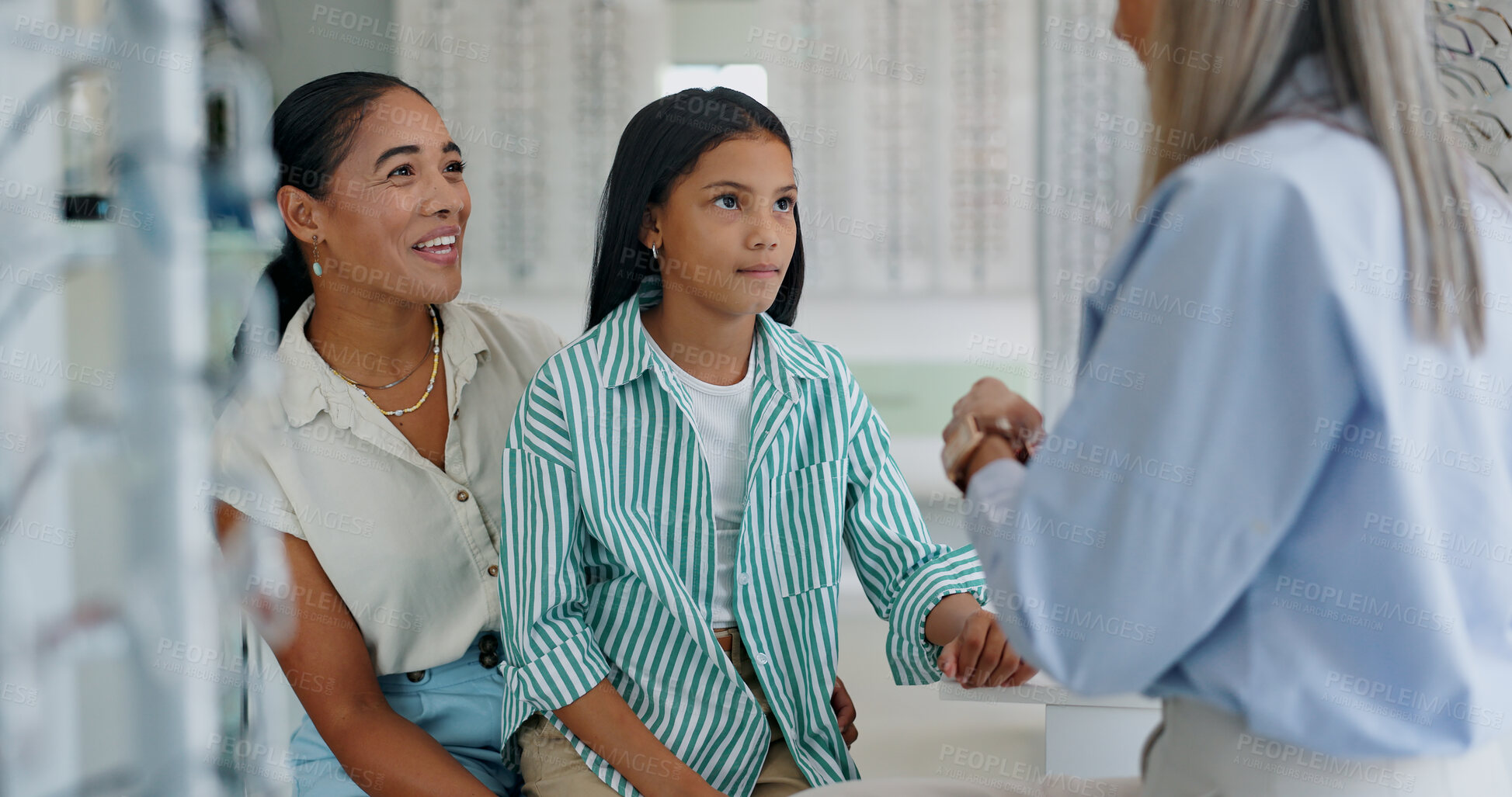 Buy stock photo Happy mother, child and glasses with optometrist for vision, sight or eye care at retail shop or store. Mom, daughter and optician helping customers try on spectacles for size, decision or choice