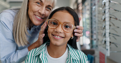 Shopping, glasses or face of child with doctor for eye care, retail and vision for help or choice. Woman, kid or portrait of girl with optician or lens for new frames or optometry for prescription