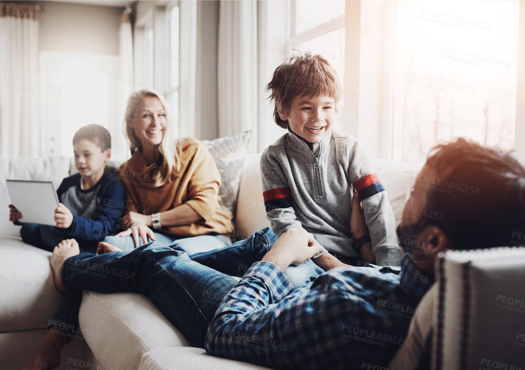 Buy stock photo Children, family and parents playing on sofa with tablet for bonding, joke or love in living room of home. Mother, father and kids with app, connection or games in apartment to relax on couch