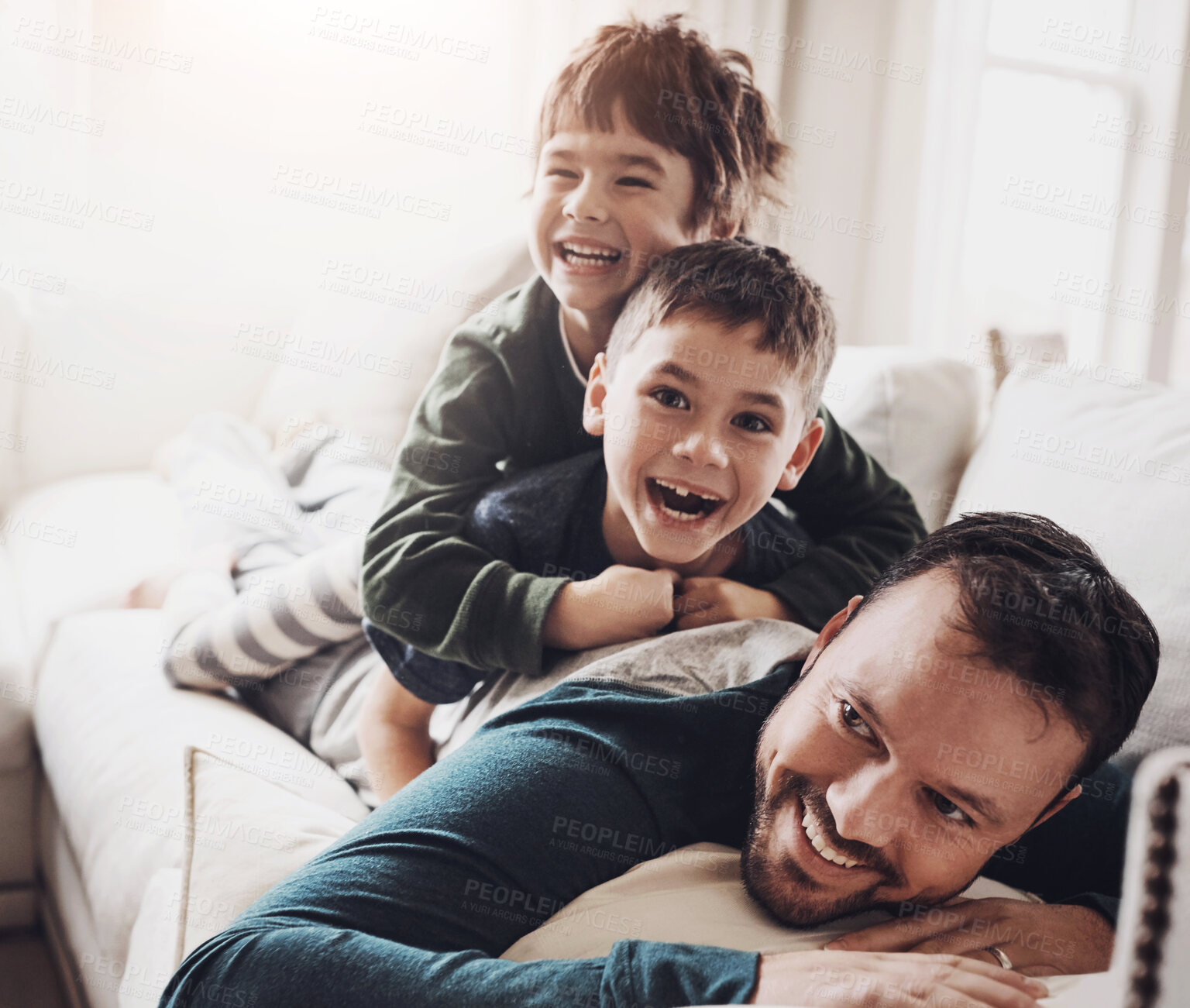 Buy stock photo Happy, dad and children in a living room at family home playing and excited together in the lounge. Hug, laughing and kids on a sofa with comedy, brother and morning with piggy back and youth