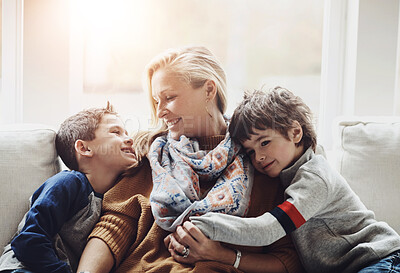 Buy stock photo Happy, relax and mother with children on sofa hugging, playing and bonding together at house. Smile, love and boy kids resting and embracing with mom on couch in living room at family home in Canada.