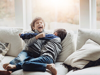 Buy stock photo Boys, kids and tickle play on couch, laughing and funny games for sibling bonding in home. Children, brothers and happiness in living room for comedy, childhood and hug for love in relationship