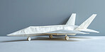 Paper plane, toys and art in studio by background for flight, global transport and recycle waste for creativity. Airplane, commercial or private jet with creativity, origami or international services