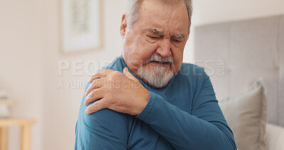 Stress, sick and senior man with shoulder pain, accident or injury for bad posture in bedroom at home. Tired, illness and elderly male person in retirement with arm muscle sprain for fatigue at house