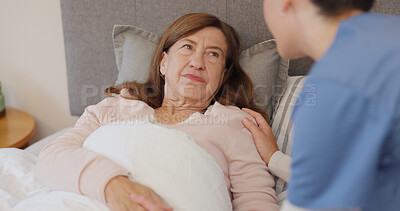 Conversation, comfort and woman in bed with nurse for empathy, support and compassion for diagnosis. Care, medical and senior female patient in discussion with caregiver in bedroom of retirement home