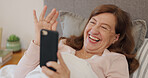 Senior, woman and phone with wave on video call in bed for hello, communication and catch up in retirement home. Elderly, person and smartphone with virtual chat, greeting and happy for conversation