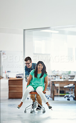 Buy stock photo Office, win or business women push chair for happiness, investment growth or startup success in company workspace. Creative, fun and people with excited face for playing, achievement and celebration