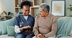 Tablet, healthcare and black nurse in home by senior man, internet and communication on wellness on sofa. African caregiver, elderly person and technology for learning and help in chronic illness