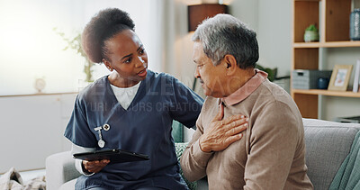 Senior, man and caregiver with tablet for consultation with coughing, chest pain and pneumonia symptoms. Elderly patient, nurse and discussion in nursing home, medical diagnosis or healthcare on sofa