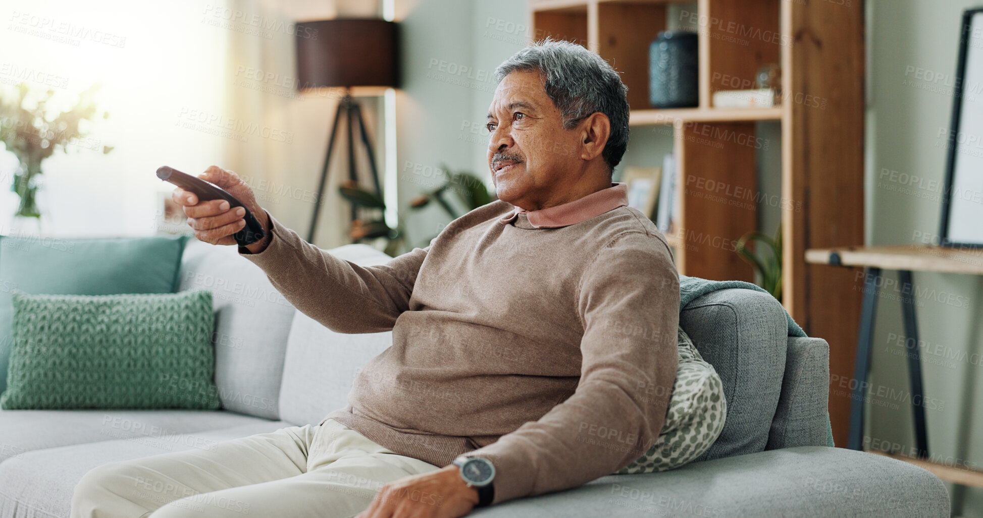 Buy stock photo Old man, face and remote for television watching in apartment for relax weekend, entertainment or retirement. Male person, smile and couch resting in house for streaming subscription, peace or movies