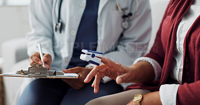 Doctor, patient, hands in closeup of oximeter to measure, diagnose or assess blood oxygen levels. Woman, stethoscope or medical technology to support healthcare communication in gp appointment