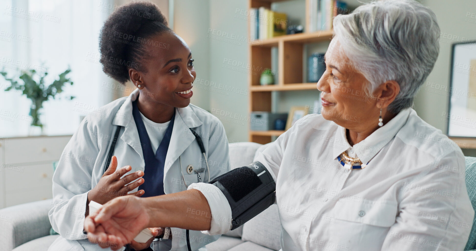 Buy stock photo Elderly, woman and doctor with monitor for blood pressure with hypertension diagnosis, medical test and cardiovascular. Senior patient, nurse and laughing in nursing home for healthcare assessment