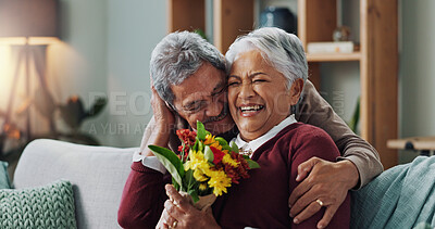Couple, woman and old man with gift of flowers on sofa or couch, happy and living room of house. Senior, male person and partner with surprise for love, smile and happiness in home and retirement