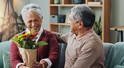Old man, woman and surprise of flower bouquet on couch, happy and couple in living room of house. Senior, male person and partner with gift for love, smile and happiness in home and retirement