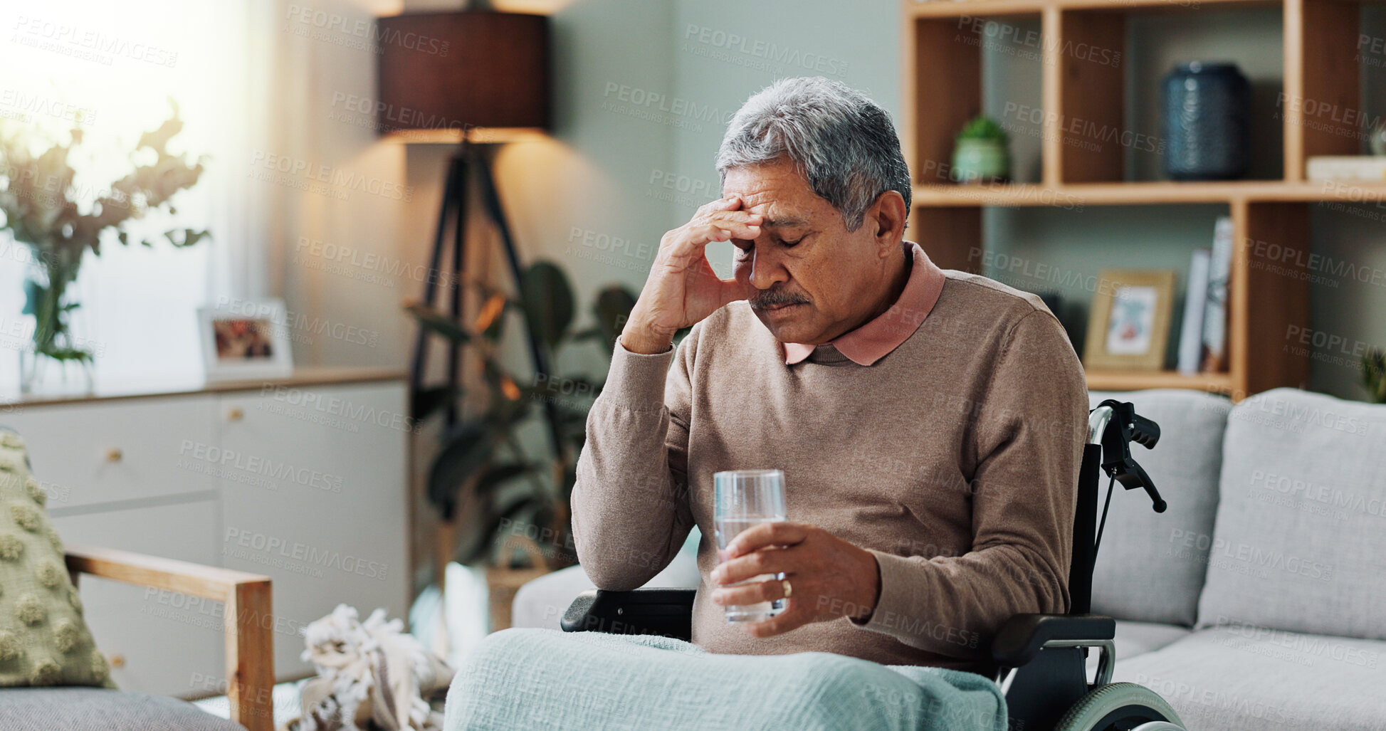 Buy stock photo Senior man, wheelchair and drinking water in home with depression, sick or stress in retirement. Glass, house and elderly person with a disability, disease or frustrated with parkinson in living room