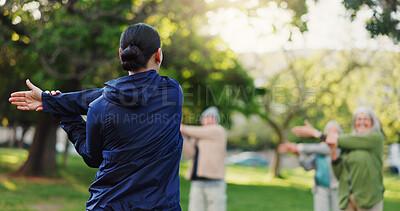 Buy stock photo Woman, personal trainer and stretching in nature for elderly care, workout or outdoor exercise. Rear view of female person, coach or instructor training mature group of people at park for fitness