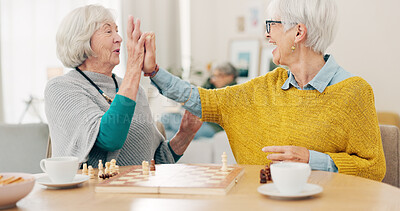 Buy stock photo Senior woman, friends and high five for chess match, game or winning on table together at home. Happy elderly women in celebration, playing strategic board game for victory or checkmate in retirement