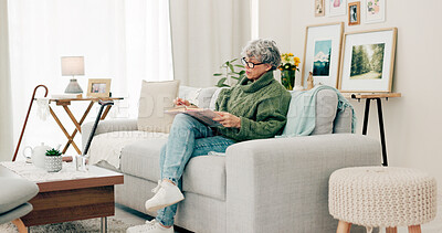 Buy stock photo Senior woman, sofa and reading book in living room for story, novel and knowledge. Elderly female person relax with books in lounge for retirement break, literature or hobby to enjoy on couch at home