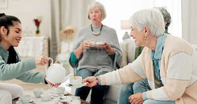 Senior women, tea and friends at a retirement home for quality time, chat or relax. Elderly people or group with a caregiver at a table for food and social visit while drinking and eating together